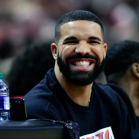 Drake smiles as he sits courtside during Game 5...