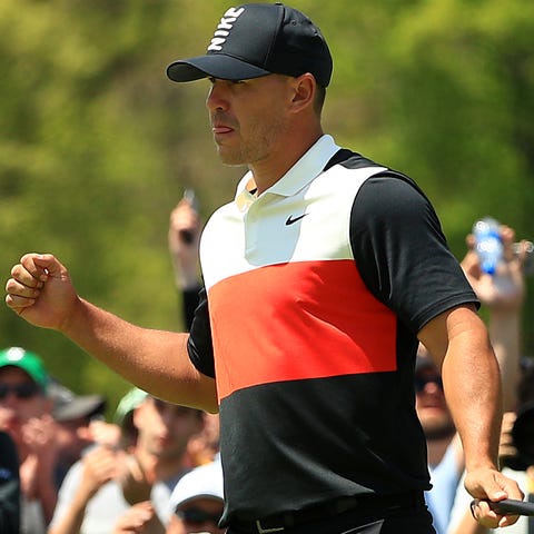 Brooks Koepka reacts on the ninth green during...