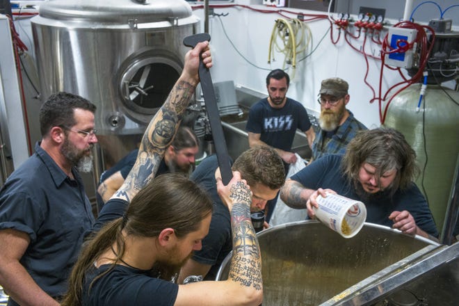 Bearded Owl Brewing co-owners Nick Babcock, center, and P.J. Hoehne, left, check the status of a mix Wednesday, May 15, 2019, with members of the heavy metal rock band Minsk, clockwise from foreground, Zachary Livingston, Christopher Bennett, Ryan Thomas, Timothy Mead and Aaron Austin. [DAVID ZALAZNIK/JOURNAL STAR]