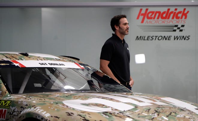 Jimmie Johnson stands by his race car for the Coca-Cola 600 during a news conference in Concord, N.C., on Tuesday. [Chuck Burton/Associated Press]