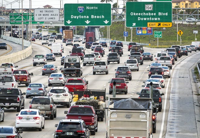 Traffic moves northbound on I-95 through West Palm Beach during the morning rush hour Friday, March 29, 2019. [LANNIS WATERS/palmbeachpost.com]