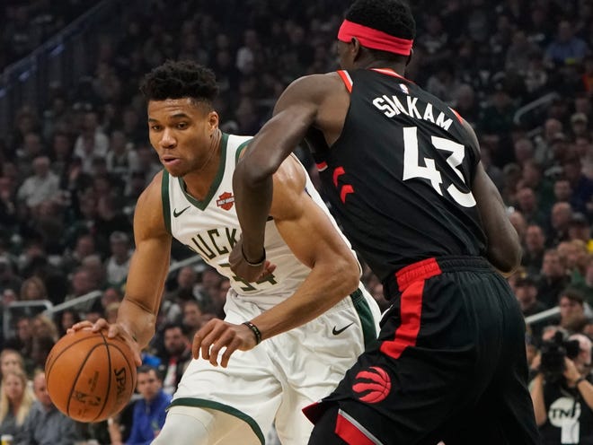 Milwaukee Bucks' Giannis Antetokounmpo tries to drive past Toronto Raptors' Pascal Siakam during the first half of Game 2 of the NBA Eastern Conference basketball playoff finals Friday, May 17, 2019, in Milwaukee. (AP Photo/Morry Gash)