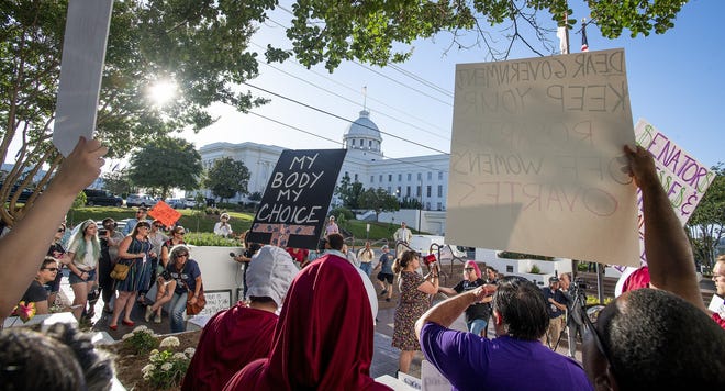 Lucia Hermo, with megaphone, leads chants during a rally against HB314, a near-total ban on abortions, outside of the Alabama State House in Montgomery, Ala., on Tuesday. [MICKEY WELSH/MONTGOMERY ADVERTISER VIA ASSOCIATED PRESS]
