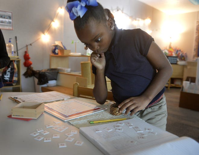 Second grader Mya Adkins, 7, works on a math project at Coastal Empire Montessori Charter School. [Steve Bisson/savannahnow.com]