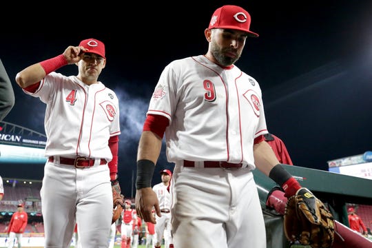 Cincinnati Reds shortstop Jose Iglesias (4) and Cincinnati Reds second baseman Jose Peraza (9) walk off the field after the win in the ninth inning during an MLB baseball game against the Chicago Cubs, Thursday, May 16, 2019, at Great American Ball Park in Cincinnati. Cincinnati won 4-2. 