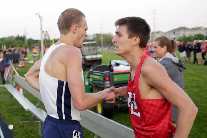 Harrison's Caleb Beimfohr and West Lafayette's Mitchell Curl shake hands after competing in the 800 meter run during the IHSAA West Lafayette boys track sectionals, Thursday, May 16, 2019 in West Lafayette.