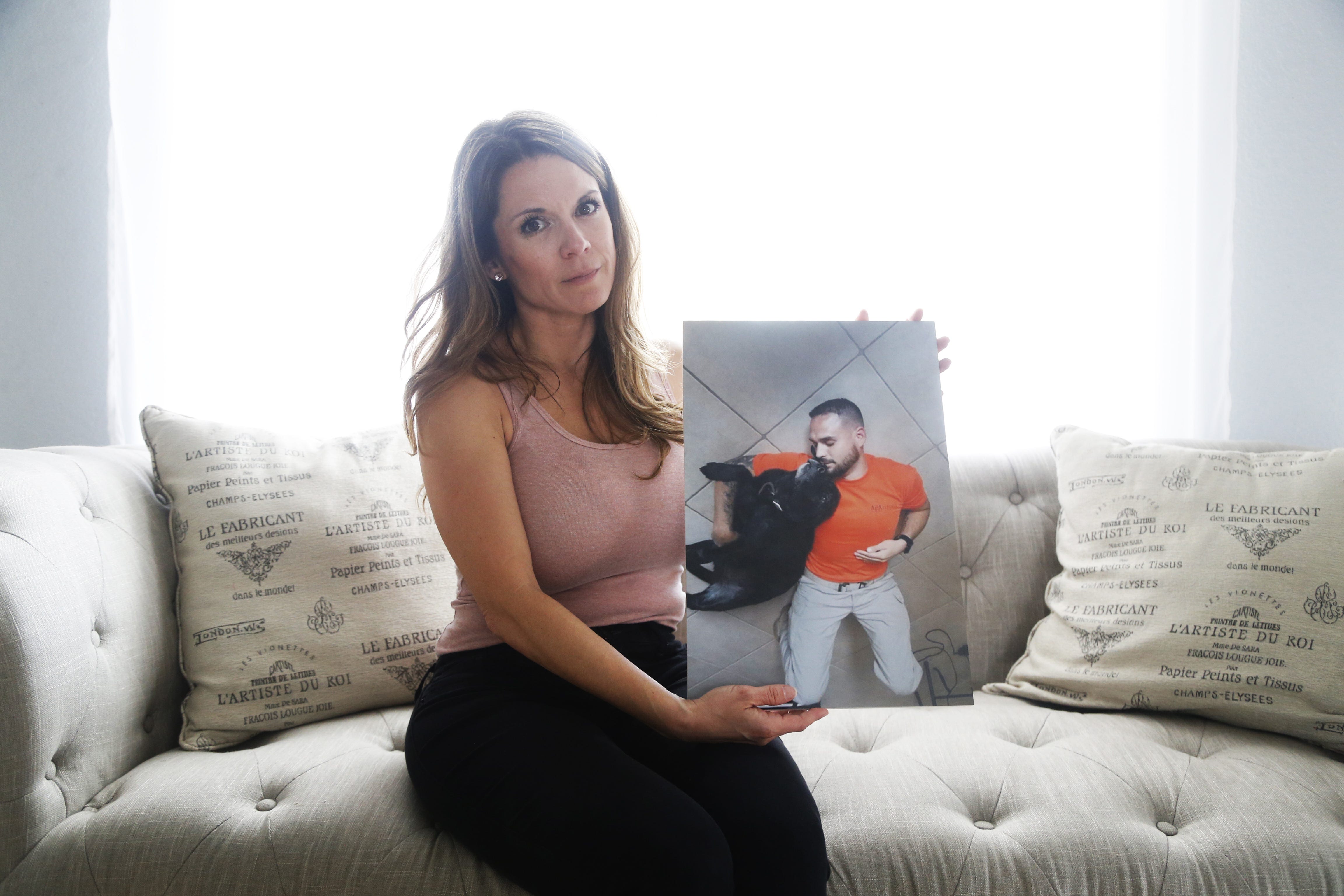 Tida Garcia holds a picture of her fiancé, Moises Balladares, a veteran who was shot by police responding to his suicide call, in her home in Avondale on April 4, 2019.