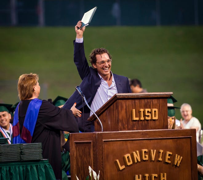 Actor and 1988 Longview High School graduate Matthew McConaughey raises his high school diploma into the air Friday upon receiving it more than 30 years after graduating. McConaughey was given his original diploma when he returned to his East Texas alma mater to address the class of 2019. [Les Hassell/The News-Journal]