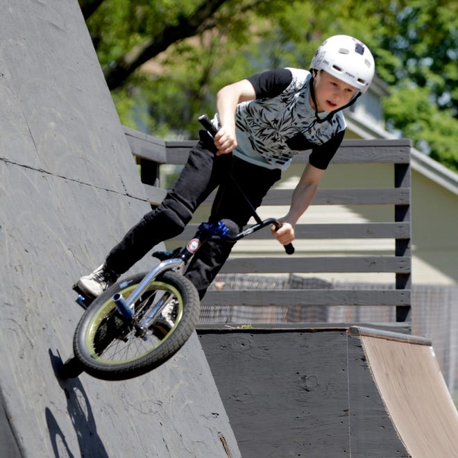 Kevin Robinson Jr., son of East Providence native and professional BMX biker Kevin "K-Rob" Robinson, tries out the ramps and walls at Saturday's dedication of the Kevin Robinson Memorial Skate Park in East Providence. [The Providence Journal / Kris Craig]