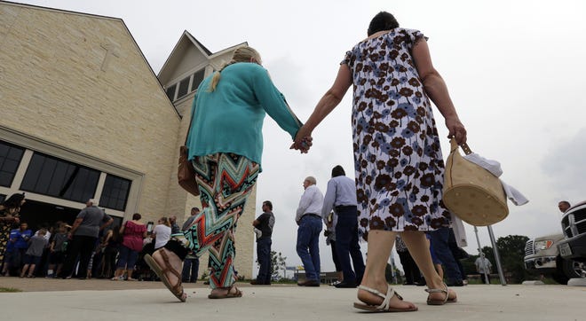 Churchgoers arrive for a dedication ceremony for a new sanctuary and memorial room at the First Baptist Church in Sutherland Springs on Sunday. A gunman killed more than two dozen congregants at the old sanctuary in 2017. [Eric Gay/The Associated Press]
