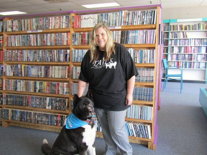 TAiLS President Shannon Seiss and her Akita, Hotch, stand in the recently opened store TAiLS of a Bookworm. [MIKE KRAMER/GATEHOUSE MEDIA ILLINOIS]