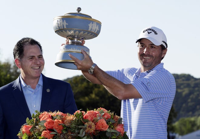 Kevin Kisner, right, holds his trophy presented by Michael Dell, CEO of Dell Technologies, after he won the Dell Technologies Match Play tournament in Austin. Some $1.27 million worth of alcohol was sold during during the tournament from March 27 to 31, according to state data. [ASSOCIATED PRESS]