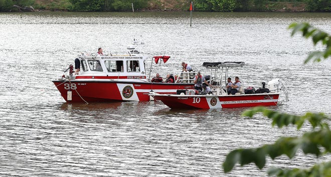 Rescue boats from the Charlotte Fire Department search the Catawba River near the Kevin Loftin Riverfront Park Boat Launch in Belmont for a man believed to be drowned after the boat he was in capsized early Monday morning. [JOHN CLARK/THE GASTON GAZETTE]