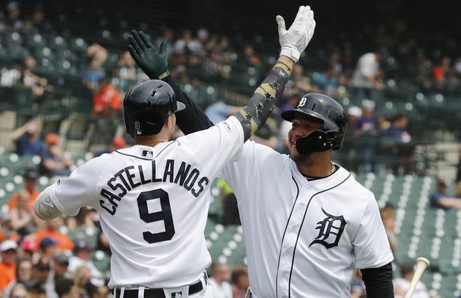 Detroit Tigers' Nicholas Castellanos (9) exchanges a high five with Miguel Cabrera after hitting a solo home run during the third inning of a baseball game against the Oakland Athletics, Sunday, May 19, 2019, in Detroit. (AP Photo/Carlos Osorio)