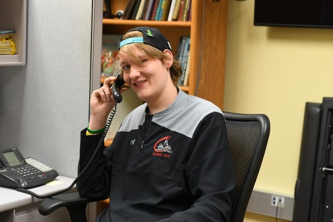 Michael Watson, 18, has been getting a lot of attention since he lost more than 100 pounds. Here, he does a phone interview with WGN radio in Chicago. [JULIE VENNITTI/CANTON REPOSITORY]