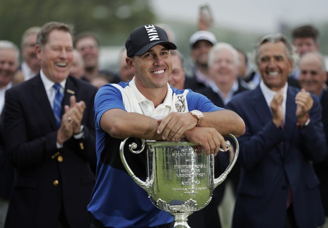 Brooks Koepka poses with the Wanamaker Trophy after winning the PGA Championship golf tournament Sunday at Bethpage Black in Farmingdale, N.Y. [AP Photo/Julio Cortez]
