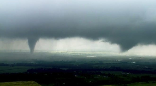 This image made from video provided by KWTV-KOTV shows two funnel clouds formed in Crescent, Okla., Monday. [KWTV-KOTV via AP]