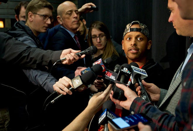 Parkrose High School football coach Keanon Lowe talks to reporters Monday in Portland, Ore. Lowe tackled a student who had pulled a weapon last Friday. Lowe is credited with preventing a shooting at the school. [AP Photo/Craig Mitchelldyer]