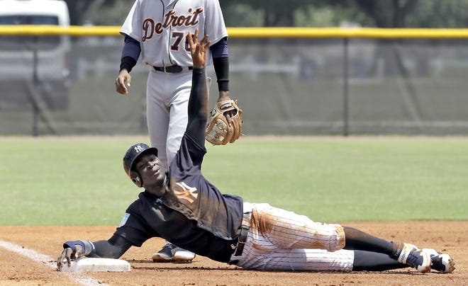 New York Yankee Didi Gregorius calls for time after sliding into third base during the first inning of a Gulf Coast League game Monday in Tampa, Florida.       

[Chris O'Meara / AP]