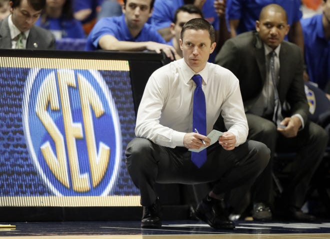 Florida basketball coach Mike White will take his team on the road or at neutral sites in eight non-conference games in the coming season. [Wade Payne/AP]