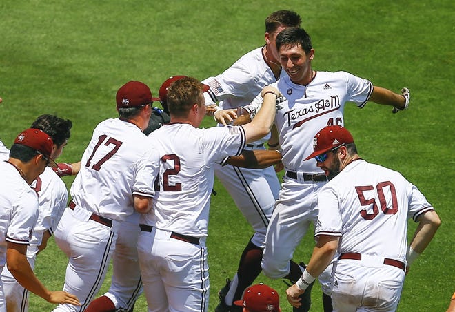 Texas A&M's Jonathan Ducoff (right rear) celebrates with teammates after hitting an RBI single during the 10th inning of the SEC tournament to defeat Florida 8-7 on Tuesday. [Butch Dill/AP]