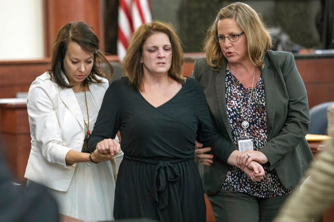 Amber Kyzer is helped out of the courtroom after breaking down on the witness stand while being questioned during the trial of her ex-husband, Tim Jones, in Columbia, S.C., Monday, May 20, 2019. Timothy Jones, Jr. is accused of killing their 5 young children in 2014. Jones, who faces the death penalty, has pleaded not guilty by reason of insanity. (Tracy Glantz/The State via AP, Pool)