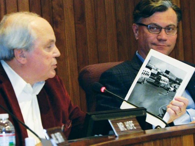 Oak Ridge Mayor Warren Gooch, left, held up a historic photograph of the Oak Ridge Shopping Center, site of the current Main Street Oak Ridge development, during his comments to representatives of RealtyLink, the site's current developer and owner at a previous meeting. He and Mayor Pro Tem Rick Chinn, at right, have praised RealtyLink for its development of the site.