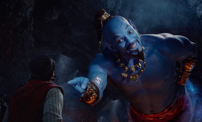Mena Massoud as Aladdin, left, and Will Smith as Genie in Disney's live-action adaptation of the 1992 animated classic "Aladdin." [Disney via AP]