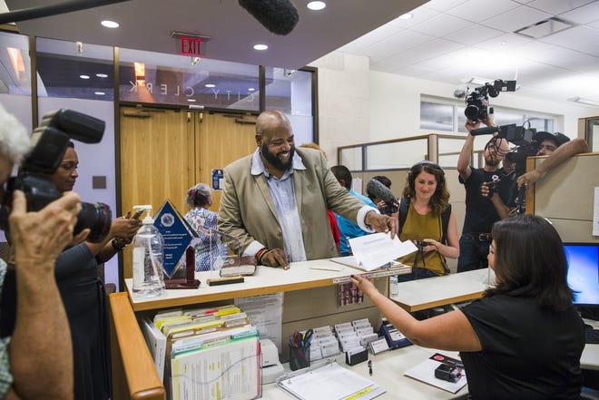 Lewis Conway Jr. submits his application for a place on the Austin City Council District 1 ballot in Austin City Hall in July 2018. Conway was attempting to challenge Texas' ban on felons running for office. [AMANDA VOISARD/AMERICAN-STATESMAN]
