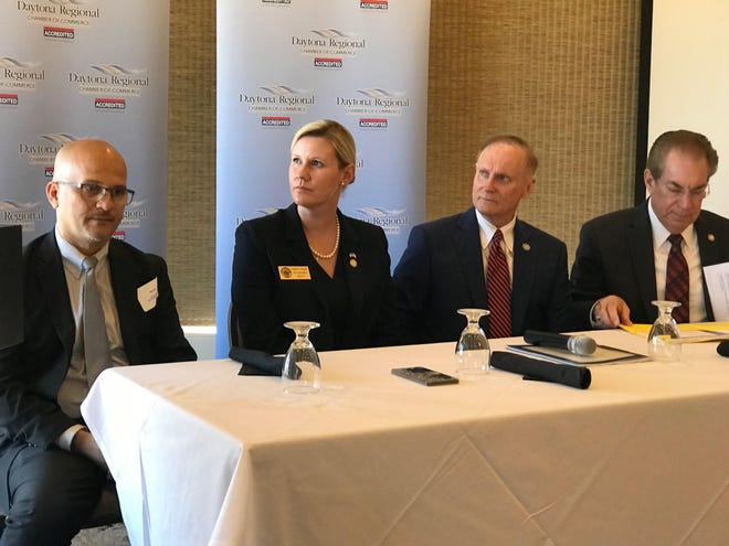 Local legislators David Santiago, Elizabeth Fetterhoff, David Simmons and Tom Wright get an earful while waiting their turn to speak about the recent session at a Daytona Regional Chamber event Wednesday. [News-Journal/Clayton Park]