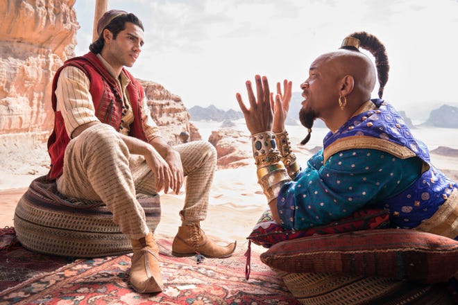 Aladdin (Mena Massoud) chats with Genie (Will Smith) about bettering himself. [Disney]