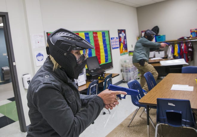 School marshal trainees go through an exercise with simulated firearms in August as part of a Texas Commission on Law Enforcement training media day at Windermere Elementary School in Pflugerville. [AMANDA VOISARD / AMERICAN-STATESMAN 2018]