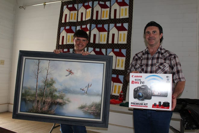 Matthew Gorman (left) and his father Lawrence Gorman (right) were big winners in the raffle at the High Grove Picnic on May 19. [LEA ANN GOERTZ LEE/ BASTROP ADVERTISER]