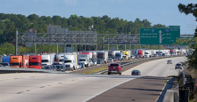 Northbound traffic on Interstate 95 was crawling Thursday afternoon after the Yellow Bluff wildfire near the Duval County/Nassau County line jumped from the east side of the interstate to the west, shutting down parts of I-95 in both directions. [Bob Self/Florida Times-Union]