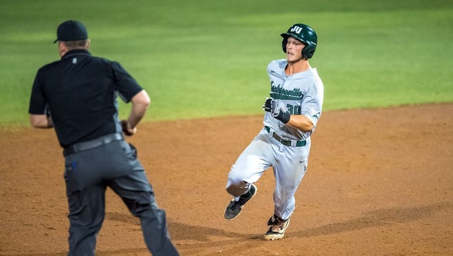 Cory Heffron of Jacksonville University avoids a base umpire on his way to third for a triple in the 10th inning of the Dolphins' 12-11 ASun baseball tournament victory over Lipscomb in DeLand. [Provided by ASun]