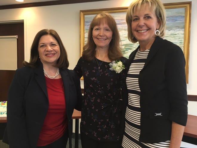 Emerson Hospital’s Compassionate Caregiver Award winner, Cathy Celli, center, is honored at the award event by Christine Schuster, president and CEO, and Joyce Welsh, chief nursing officer of Emerson Hospital. [SUBMITTED PHOTO]