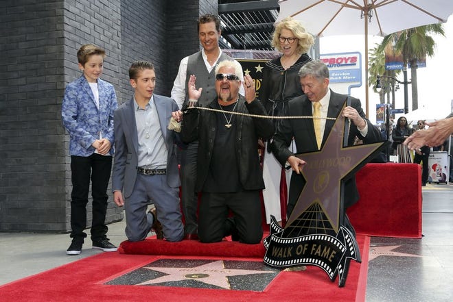 Ryder Fieri, from left, Hunter Fieri, Matthew McConaughey, Guy Fieri, Kathleen Finch and Leron Gubler unveil a star during a ceremony honoring Fieri with a star at the Hollywood Walk of Fame on Wednesday, May 22, 2019, in Los Angeles. (Photo by Willy Sanjuan/Invision/AP)