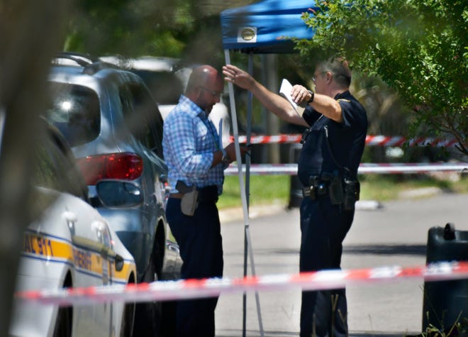 Jacksonville police investigate the scene of Friday's shooting death at North Dover Cliff Drive and Pilgrims Trace Drive where a resident killed an apparent intruder. [Will Dickey/Florida Times-Union]