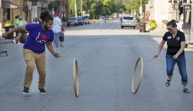 Games like hoop racing will be among the activities available at the June 8 Super Saturday at the Lincoln Heritage Museum on the Lincoln College Campus. In this file photo, Lincoln College student Maurice Moore and Lincoln Heritage Museum Director Anne Moseley demonstrate hoop racing. [Photo courtesy of Lincoln College]