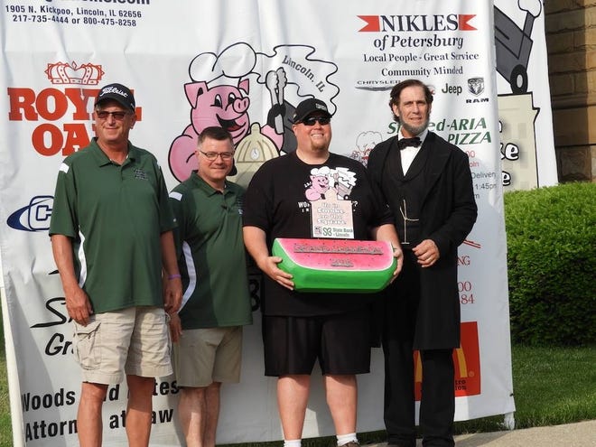 Mark Rasmussen, of Grand Haven Michigan, won the 2018 Up in Smoke on the Square KCBS competition in Lincoln. Pictured from left: Steve Aughenbaugh, Chris Graue, Rasmussen and Randy Duncan, Lincoln impersonator. The 2019 contest is scheduled for May 31 and June 1 in Lincoln. [Photo courtesy Up in Smoke on the Square Facebook page]