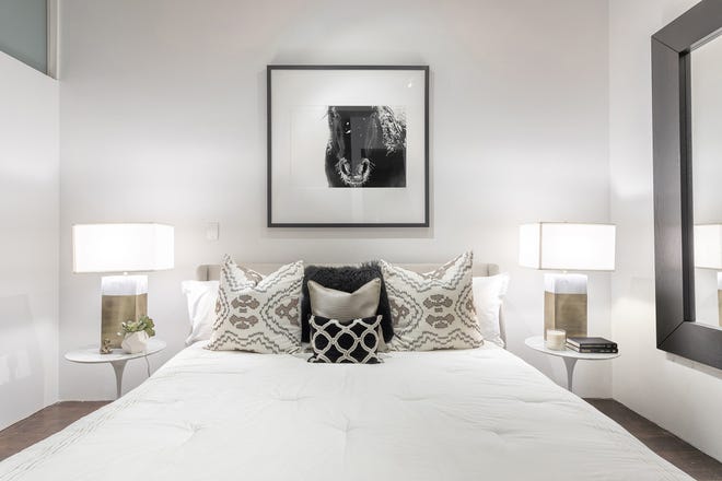 Light bedding and large mirrors make a master bedroom with only an interior window as its light source feel open and bright. [Design Recipes]