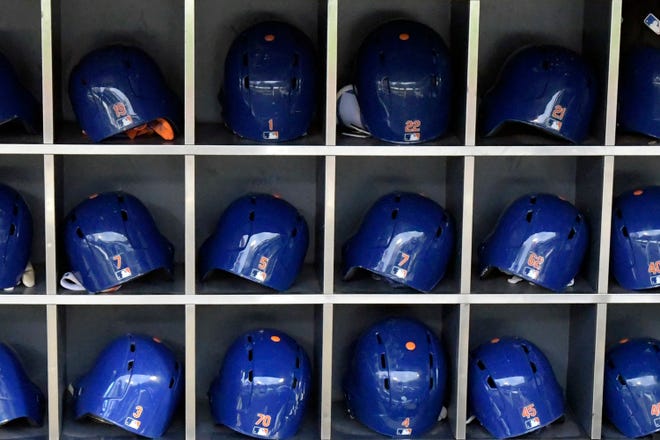 This Sept. 28, 2018 photo shows batting helmets in a rack before a Major League Baseball game in New York. According to study published Friday, May 24, 2019, NFL players may be more likely to die from brain diseases and heart problems than MLB players but the reasons are unclear. (AP Photo/Bill Kostroun)