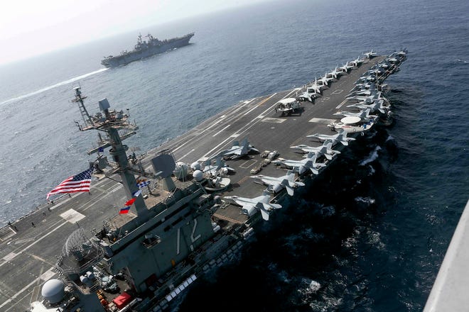 The USS Abraham Lincoln is seen May 17 sailing in the Arabian Sea near the amphibious assault ship USS Kearsarge.