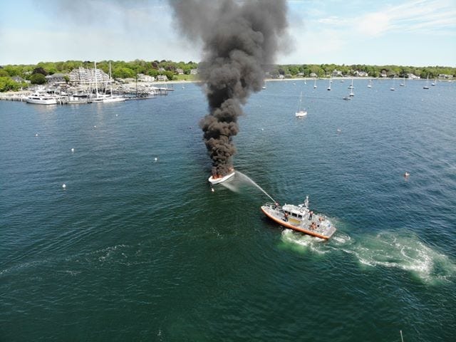 Smoke billows from a 36-foot-long vessel which appeared to be destroyed by a fire near the East Ferry Landing in Jamestown Saturday. [Contributed photo / Ian Maccini]