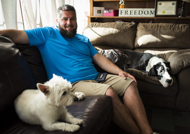 Stephen Mandile of Uxbridge, pictured with dogs Bella and Sydney, is leading efforts through his advocacy groups, Veterans' Alternative Healing and Alternative Treatment for Veterans, to expand access to medical marijuana for veterans. [T&G Staff/Ashley Green]
