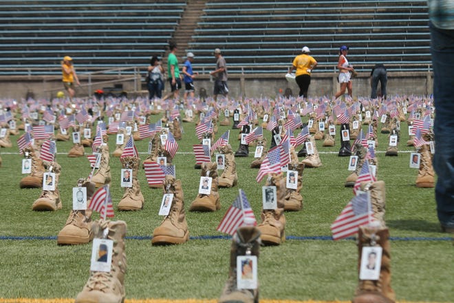 Volunteers place more than 7,500 boots at Hedrick Stadium on May 17 to represent service members who have died since 9/11. [Rachael Riley/The Fayetteville Observer]