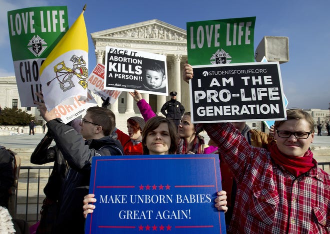FILE - In this Friday, Jan. 18, 2019, file photo, anti-abortion activists protest outside of the U.S. Supreme Court, during the March for Life in Washington. The passage of abortion restrictions in Republican-led states and a corresponding push to buttress abortion rights where Democrats are in power stem from the same place: Changes in the composition of the high court. (AP Photo/Jose Luis Magana, File)
