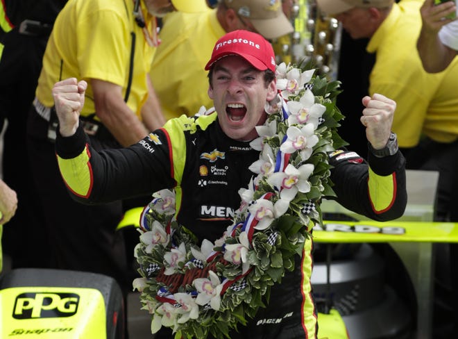 Simon Pagenaud of France celebrates after winning the Indianapolis 500 IndyCar auto race at Indianapolis Motor Speedway on Sunday in Indianapolis. [MICHAEL CONROY/THE ASSOCIATED PRESS]