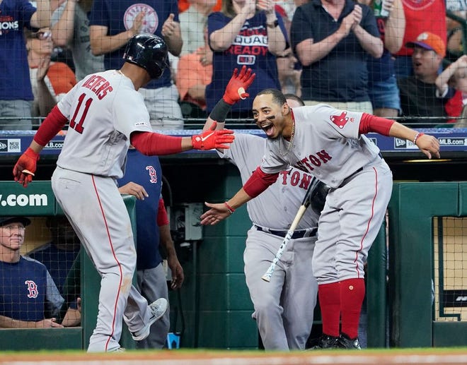 The Red Sox' Rafael Devers, left, celebrates with Mookie Betts after hitting a home run during the fourth inning of Sunday's game in Houston.