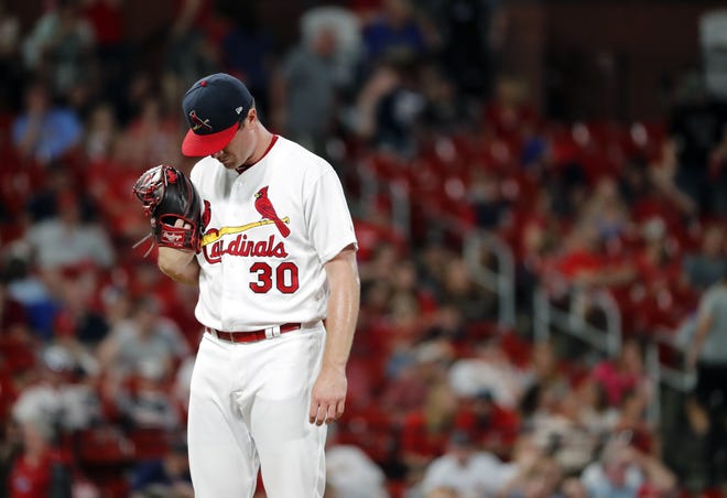 St. Louis Cardinals relief pitcher Tyler Webb waits to be removed after giving up a bases-loaded walk to Atlanta Braves' Brian McCann, scoring Freddie Freeman during the 10th inning Sunday in St. Louis. [JEFF ROBERSON/THE ASSOCIATED PRESS]